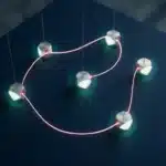 Leuchtend rosa Lichtfaden verbindet fünf geometrische Knoten in Konstellationsform auf dunkelblauem Untergrund mit türkisfarbenen Halos.